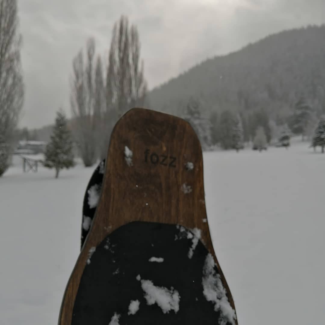Fozz Longboard standing upright in fresh snow
